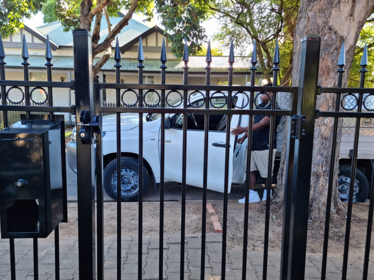 Black spear-top tubular gate with a built-in letterbox